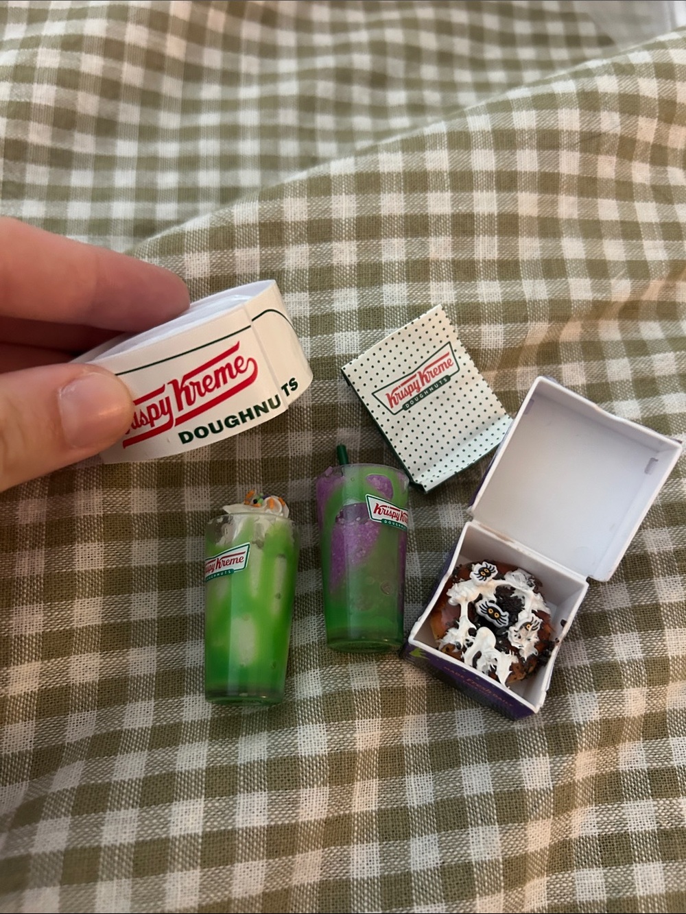mini verse krispy kreme collection uv light, 2 drinks, donut in box, and bag